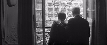 Movie still from “Shoot the Piano Player” (1960), directed by François Truffaut – Two men looking out of a window at a building; Medium shot, Over the shoulder angle