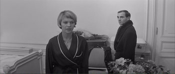 Movie still from “Shoot the Piano Player” (1960), directed by François Truffaut – A man and a woman standing next to each other in a room; Medium shot, Over the shoulder angle