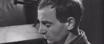 Movie still from “Shoot the Piano Player” (1960), directed by François Truffaut – A person's face in a black and white photo; Close Up shot, Low angle