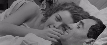 Movie still from “Shoot the Piano Player” (1960), directed by François Truffaut – A man and a woman laying in a bed together; Close Up shot, Overhead angle