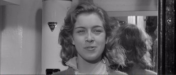 Movie still from “Shoot the Piano Player” (1960), directed by François Truffaut – A black - and - white photo of a woman's face; Close Up shot, Over the shoulder angle