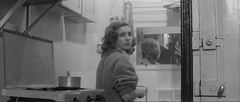 Movie still from “Shoot the Piano Player” (1960), directed by François Truffaut – A young woman standing in front of a mirror; Medium shot, Over the shoulder angle