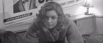 Movie still from “Shoot the Piano Player” (1960), directed by François Truffaut – A black - and - white photo of a woman with curly hair; Close Up shot, High angle