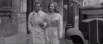 Movie still from “Shoot the Piano Player” (1960), directed by François Truffaut – A man and a woman standing next to each other on the street; Medium shot, High angle