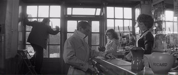 Movie still from “Shoot the Piano Player” (1960), directed by François Truffaut – A man and a woman are working at a counter; Medium shot, Low angle