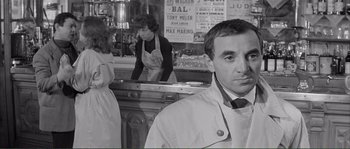 Movie still from “Shoot the Piano Player” (1960), directed by François Truffaut – A black and white photo of a man and a woman in a restaurant; Medium shot, Over the shoulder angle