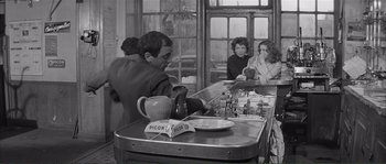 Movie still from “Shoot the Piano Player” (1960), directed by François Truffaut – An old black and white photo of people at a bar; Medium shot, Over the shoulder angle
