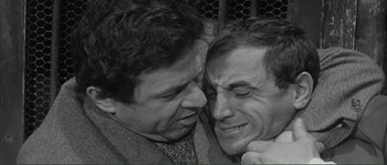 Movie still from “Shoot the Piano Player” (1960), directed by François Truffaut – A black - and - white photo of two men embracing each other; Close Up shot, High angle