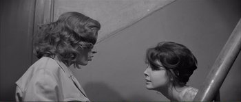 Movie still from “Shoot the Piano Player” (1960), directed by François Truffaut – Two women face each other in a room; Close Up shot, High angle