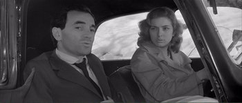 Movie still from “Shoot the Piano Player” (1960), directed by François Truffaut – A black and white photo of a man and a woman in the backseat of a car; Close Up shot, Low angle