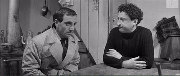 Movie still from “Shoot the Piano Player” (1960), directed by François Truffaut – Two men sitting at a table talking to each other; Medium shot, Over the shoulder angle