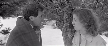 Movie still from “Shoot the Piano Player” (1960), directed by François Truffaut – A man and a woman standing next to a tree; Medium shot, Over the shoulder angle