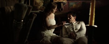 Movie still from “Godless” (2017), directed by Scott Frank – A man and a woman sitting on the ground; Medium shot, Low angle