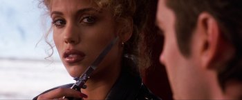 Movie still from “Showgirls” (1995), directed by Paul Verhoeven – A person holding a pair of scissors; Close Up shot, Over the shoulder angle