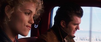 Movie still from “Showgirls” (1995), directed by Paul Verhoeven – A man and a woman sitting in a car; Close Up shot, Over the shoulder angle