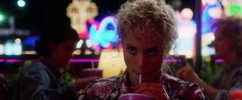 Movie still from “Showgirls” (1995), directed by Paul Verhoeven – A person drinking a drink from a straw; Close Up shot, Over the shoulder angle