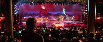 Movie still from “Showgirls” (1995), directed by Paul Verhoeven – People are sitting in front of a large screen; Extreme Wide shot, High angle