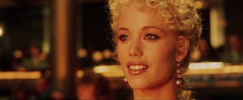 Movie still from “Showgirls” (1995), directed by Paul Verhoeven – A woman with blonde hair; Close Up shot, Over the shoulder angle