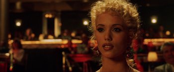 Movie still from “Showgirls” (1995), directed by Paul Verhoeven – A person with curly hair; Close Up shot, Over the shoulder angle
