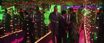 Movie still from “Showgirls” (1995), directed by Paul Verhoeven – A group of men in suits standing in front of a mirror; Wide shot, Low angle