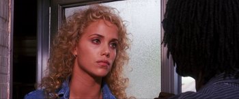Movie still from “Showgirls” (1995), directed by Paul Verhoeven – A person with curly hair; Close Up shot, Over the shoulder angle