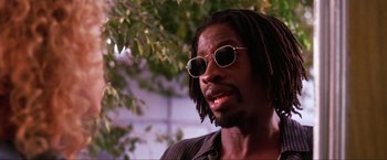 Movie still from “Showgirls” (1995), directed by Paul Verhoeven – A person wearing sunglasses; Close Up shot, Low angle