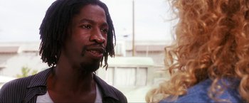 Movie still from “Showgirls” (1995), directed by Paul Verhoeven – A person talking to another person; Close Up shot, Low angle