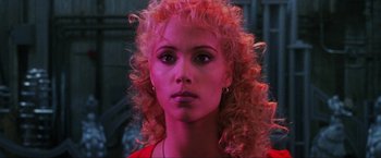 Movie still from “Showgirls” (1995), directed by Paul Verhoeven – A person with pink hair; Close Up shot, Low angle