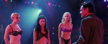 Movie still from “Showgirls” (1995), directed by Paul Verhoeven – A couple of women standing next to each other on a stage; Medium shot, Over the shoulder angle