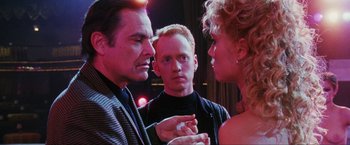 Movie still from “Showgirls” (1995), directed by Paul Verhoeven – A group of people that are standing around each other; Close Up shot, Over the shoulder angle