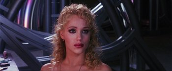 Movie still from “Showgirls” (1995), directed by Paul Verhoeven – A person with curly blonde hair; Close Up shot, Over the shoulder angle
