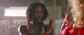 Movie still from “Showgirls” (1995), directed by Paul Verhoeven – A person with dreadlocks; Close Up shot, Low angle