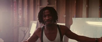 Movie still from “Showgirls” (1995), directed by Paul Verhoeven – A person with dreadlocks; Close Up shot, Low angle