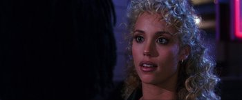 Movie still from “Showgirls” (1995), directed by Paul Verhoeven – A person with curly blonde hair; Close Up shot, Over the shoulder angle
