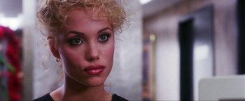 Movie still from “Showgirls” (1995), directed by Paul Verhoeven – A person wearing a black shirt; Close Up shot, Over the shoulder angle