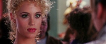 Movie still from “Showgirls” (1995), directed by Paul Verhoeven – A woman with a green eye; Close Up shot, Over the shoulder angle