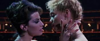 Movie still from “Showgirls” (1995), directed by Paul Verhoeven – Two women with make - up touching each other's face; Close Up shot, Overhead angle