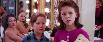 Movie still from “Showgirls” (1995), directed by Paul Verhoeven – Two young children standing next to each other in front of a mirror; Close Up shot, Over the shoulder angle