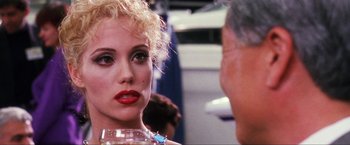 Movie still from “Showgirls” (1995), directed by Paul Verhoeven – A person wearing a necklace; Close Up shot, Over the shoulder angle
