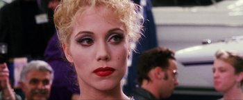 Movie still from “Showgirls” (1995), directed by Paul Verhoeven – A person with makeup on; Close Up shot, Over the shoulder angle
