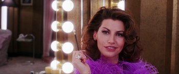 Movie still from “Showgirls” (1995), directed by Paul Verhoeven – A woman in a purple dress holding a wand; Close Up shot, Low angle