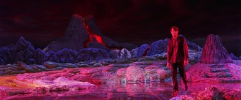 Movie still from “Showgirls” (1995), directed by Paul Verhoeven – A painting of a mountain with a lava flow in the background; Extreme Wide shot, High angle