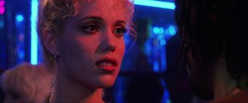 Movie still from “Showgirls” (1995), directed by Paul Verhoeven – A woman's face in the dark; Close Up shot, Over the shoulder angle