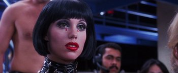 Movie still from “Showgirls” (1995), directed by Paul Verhoeven – A woman in a black outfit with red lipstick; Close Up shot, Low angle