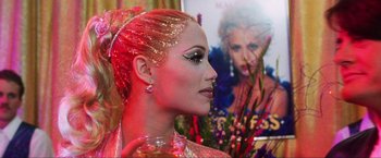 Movie still from “Showgirls” (1995), directed by Paul Verhoeven – A person wearing a costume; Close Up shot, Over the shoulder angle