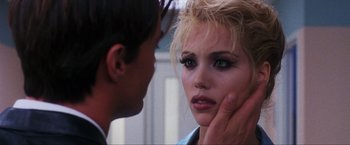 Movie still from “Showgirls” (1995), directed by Paul Verhoeven – A man touching the face of a beautiful woman; Close Up shot, Over the shoulder angle