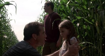 Movie still from “Signs” (2002), directed by M. Night Shyamalan – A man and a little girl in front of a tree; Medium shot, Over the shoulder angle
