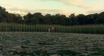 Movie still from “Signs” (2002), directed by M. Night Shyamalan – A group of people standing on top of a corn field; Extreme Wide shot, High angle