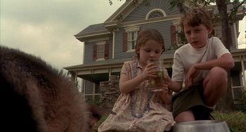 Movie still from “Signs” (2002), directed by M. Night Shyamalan – A little girl is drinking a glass of water; Medium shot, Low angle