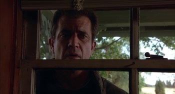 Movie still from “Signs” (2002), directed by M. Night Shyamalan – A person looking through a window; Close Up shot, Low angle